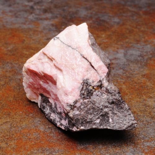 Raw Rhodonite crystal metaphysical properties, meanings, uses, benefits, healing energies, chakras